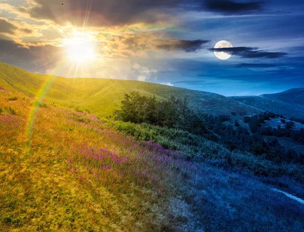 Yazın güzel dağ manzarası. Gündüz ve gece zaman kavramını değiştirir. Alacakaranlıkta güneşi ve ayı olan yeşil çimenli tepelerin manzarası. Astroloji duvar kağıdı