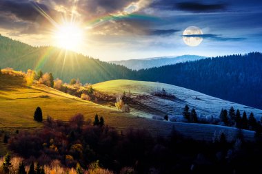 autumn landscape of rural region in mountains. day and night time change concept. rolling hills with green alps with sun and moon. serene countryside under cloudy sky. duality and transition template