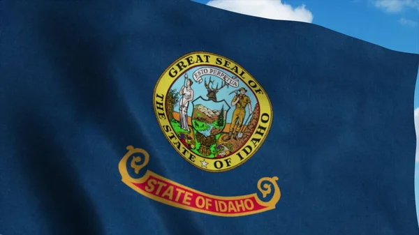 Bandera de Idaho ondeando en el viento, fondo azul del cielo. renderizado 3d — Foto de Stock