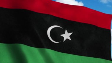 Libya Ulusal Bayrağı rüzgarda dalgalanıyor, mavi gökyüzü arka planı. 4K