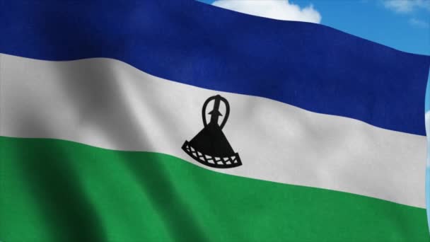 Lesothova vlajka vlnící se ve větru, pozadí modré oblohy. 4K — Stock video