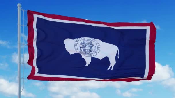 Bendera Wyoming pada tiang bendera melambai dalam angin, latar langit biru. 4K — Stok Video