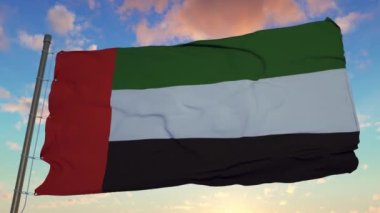 Birleşik Arap Emirlikleri 'nin bayrağı gün batımında güzel gökyüzüne karşı rüzgarda sallanıyor.