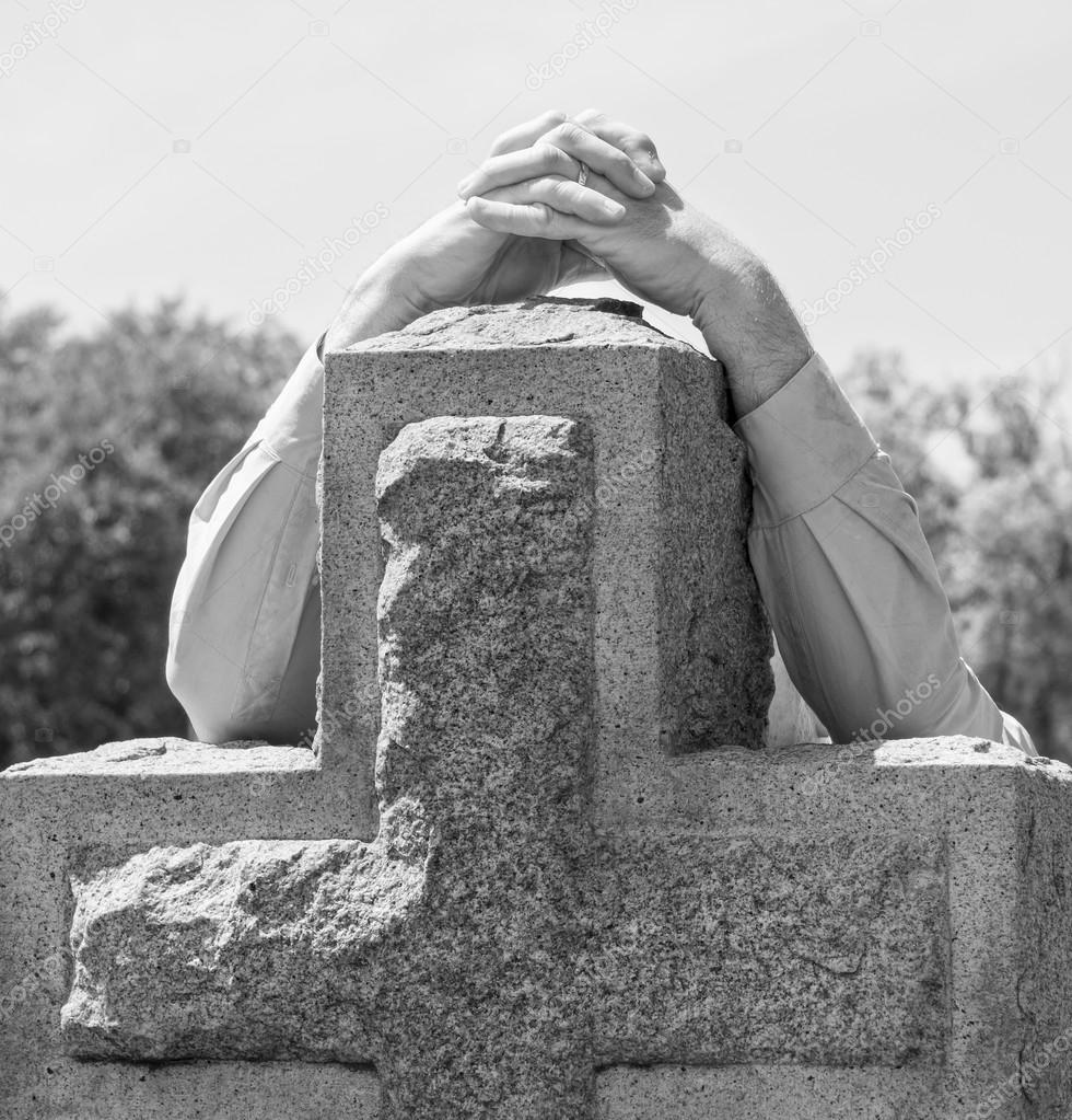 Lone Figure of Person in Black and White Grieving at Cemetery