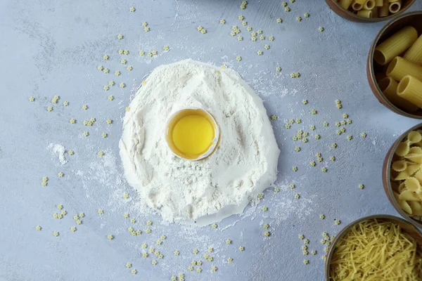 Ingredients for homemade pasta. Food background: macaroni, spagetti, egg, flour — Stock Photo, Image