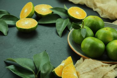 Arka planda yetişen yeşil tatlı mandalinalar