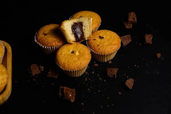 Cupcakes em um fundo preto. Cozimento — Fotografia de Stock