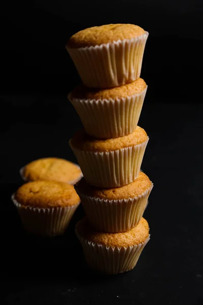Cupcakes on a black background. Baking — Stock Photo, Image