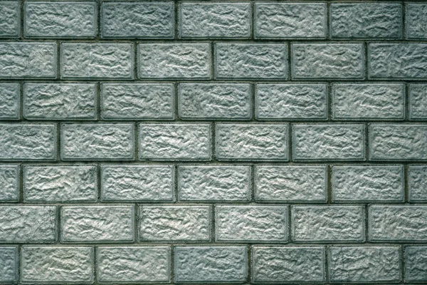 콘크리트 블록으로 만들어 연세가 청록색 배경이나 벽지에 착색되었다 벽돌로 만드는 — 스톡 사진