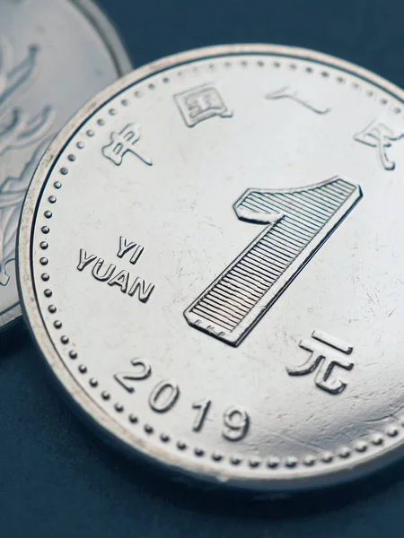 1 one Chinese yuan coins close-up. Blue tinted vertical illustration about the economy, business, money and finance of PRC. National currency of China. Yuan of the new sample of 2019. Macro