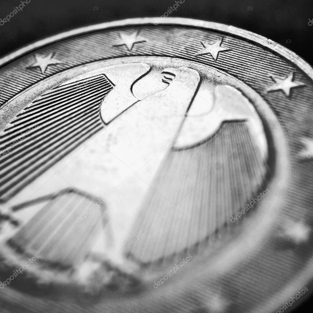 1 euro coin issued in Germany close-up. Obverse with the Federal Eagle. Dark black and white square illustration for European Union currency and German economy news. Macro