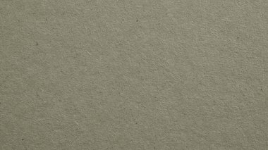 Gri mukavvanın yüzeyi. Selüloz lifli kağıt dokusu. Kağıt duvar kağıdı. Geniş gri renkli bir arka plan. Dokulu, büyüleyici ve zarif bir zemin. Baştan aşağı. Makro