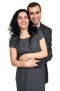 Çift kucaklama, beyaz stüdyo portre. Siyah takım elbise giymiş.