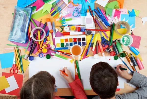 Child drawing top view. Artwork workplace with creative accessories. Flat lay art tools for painting. — Stock Photo, Image