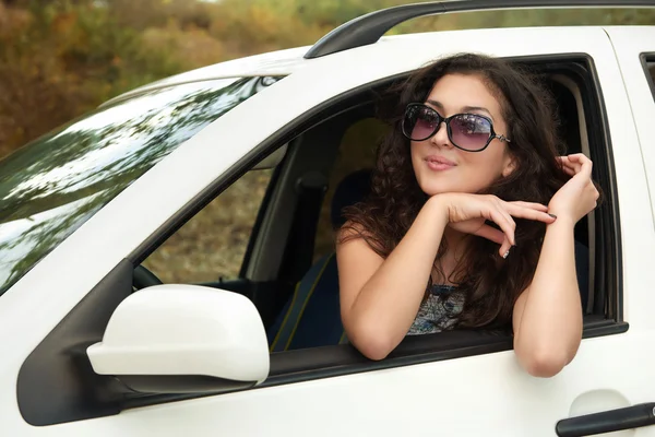 Chica conductor dentro de coche retrato, mirar a la distancia a través de gafas de sol, temporada de verano — Foto de Stock