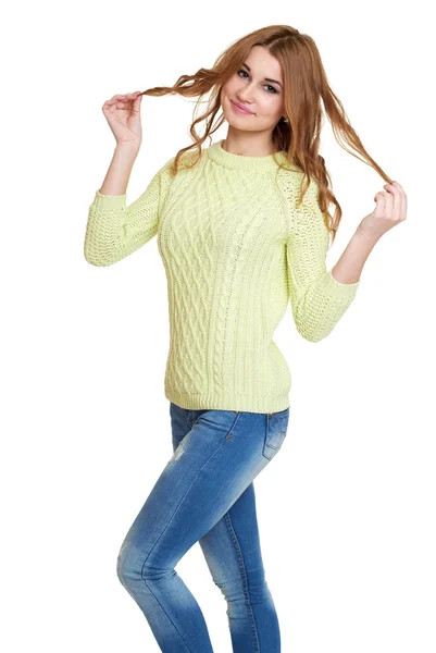젊은 여자 캐주얼 옷을 입고 청바지와 흰색 바탕에 스튜디오에서 포즈 녹색 스웨터 — 스톡 사진