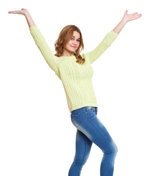 Young girl casual dressed jeans and a green sweater posing open arms in studio on white background — Stock Photo, Image