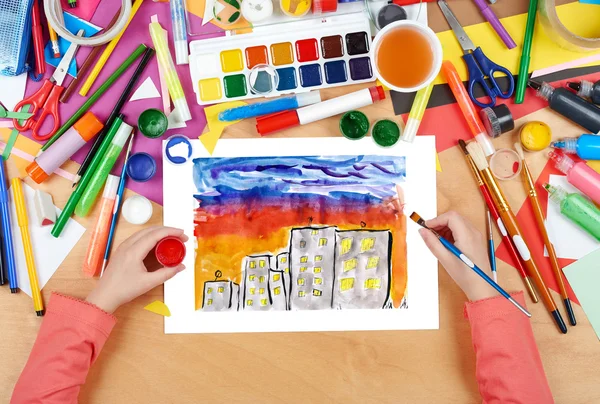 Child drawing night city, top view hands with pencil painting picture on paper, artwork workplace — Stock Photo, Image