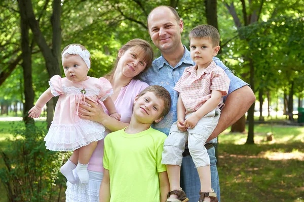 Happy family portrait on outdoor, group of five people posing in city park, summer season, child and parent — Stock Photo, Image