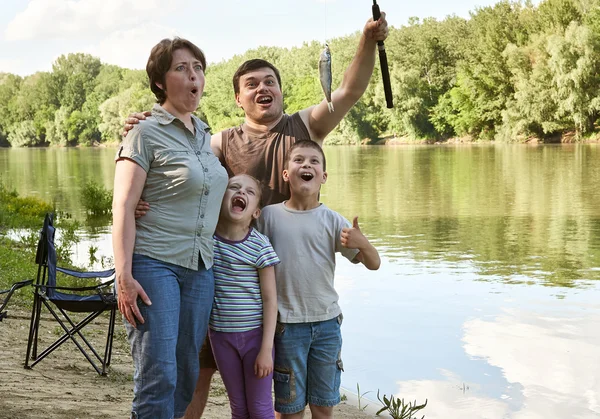 Family with emotion catch fish, people camping and fishing, leisure in nature, river and forest, summer season — Stock Photo, Image