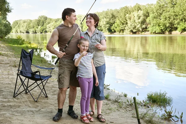 People camping and fishing, family active in nature, fish caught on bait, river and forest, summer season — Stock Photo, Image