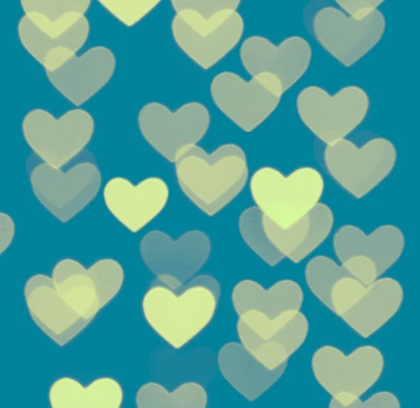 Heart bokeh achtergrond, foto wazig objecten, geel op blauw — Stockfoto