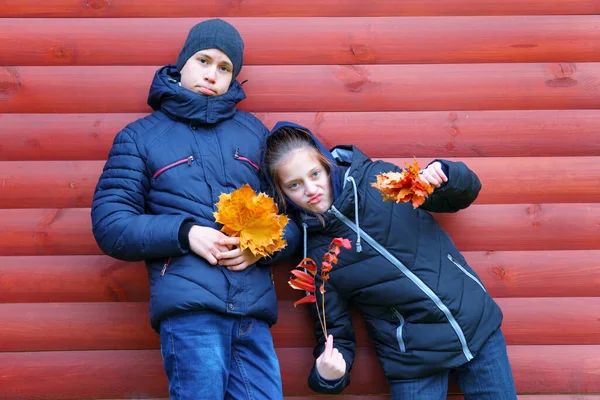 Una Ragazza Felice Ragazzo Posa Vicino Muro Legno Rosso Gode — Foto Stock