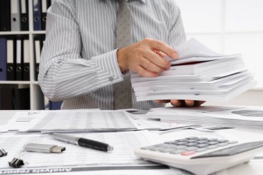 İş dünyası konsepti - iş adamının çalışma masası yakın görünümü, mali raporları kontrol etmesi, yazması ve sayması