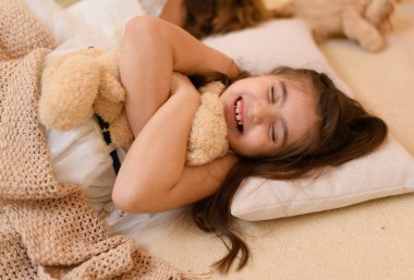 Kızlar yerde yatar, konuşur ya da uyur ve üzerlerini battaniyeyle örterler. Evin içi Noel ışıkları ve hediyelerle süslenir.