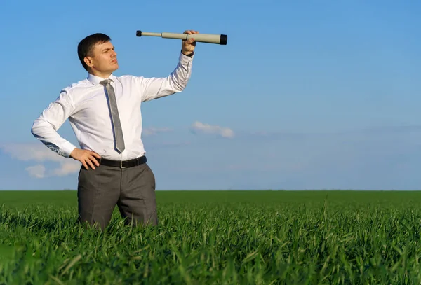 Businessman Poses Spyglass Looks Distance Looks Something Green Grass Blue — Stock Photo, Image