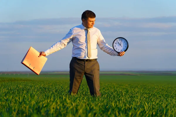 Businessman Holds Office Clock Red Folder Field Green Grass Business — Stock Photo, Image