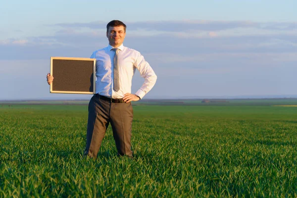 Businessman Holds Blackboard Empty Space Poses Green Grass Field Business — Stock Photo, Image