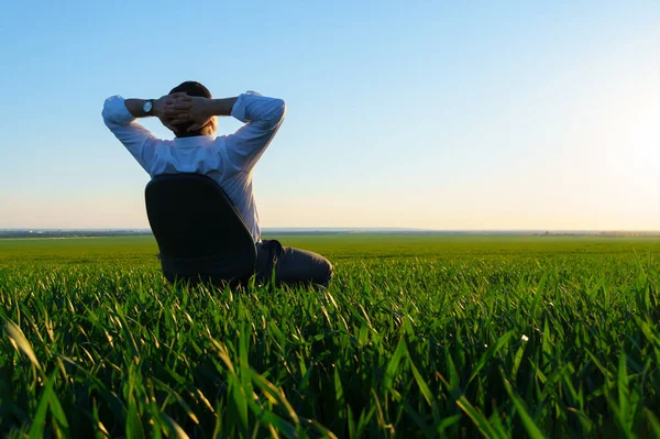 Geschäftsmann Sitzt Bürostuhl Auf Einem Feld Und Ruht Sich Aus — Stockfoto