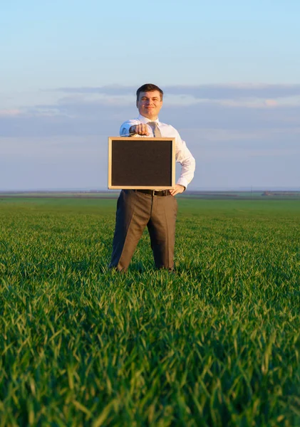 Businessman Holds Blackboard Empty Space Poses Green Grass Field Business — Stock Photo, Image