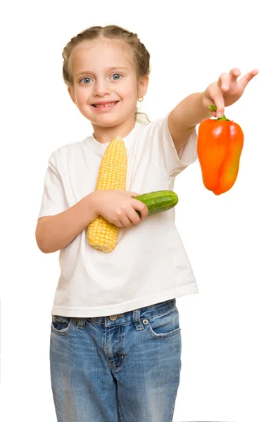 Liten flicka med frukt och grönsaker på vit — Stockfoto