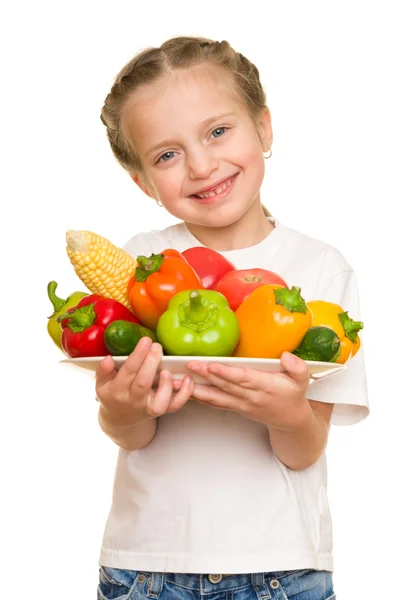 Kleines Mädchen mit Obst und Gemüse auf weißem Grund — Stockfoto