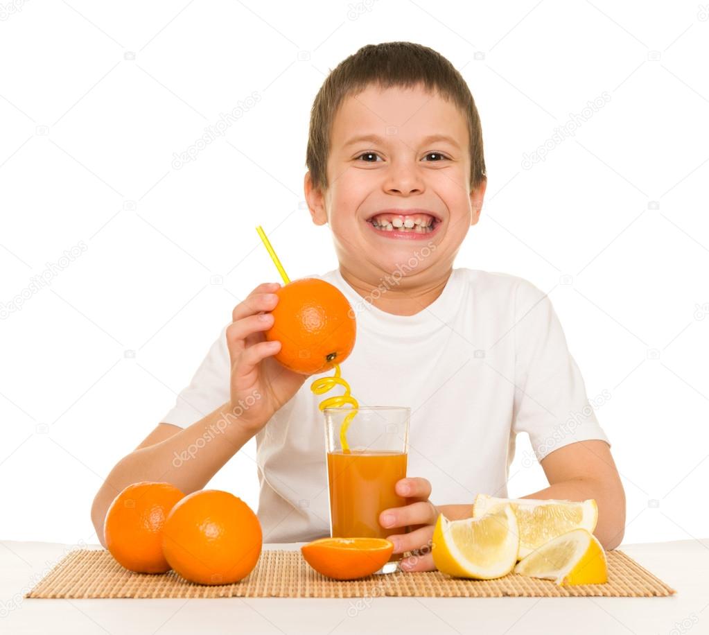 Boy drink orange juice with a straw Stock Photo by ©soleg 55481017