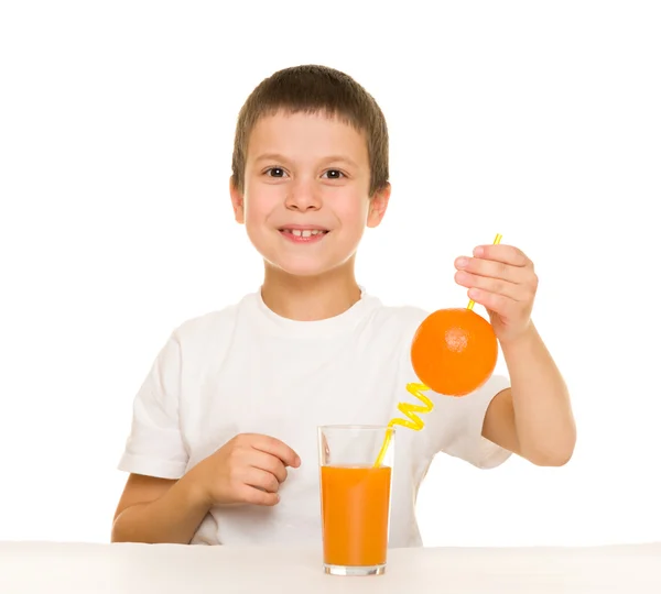 Boy drink orange juice with a straw — Stock Photo, Image