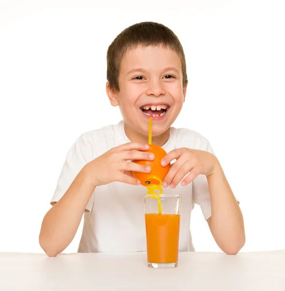 Boy drink orange juice with a straw — Stock Photo, Image