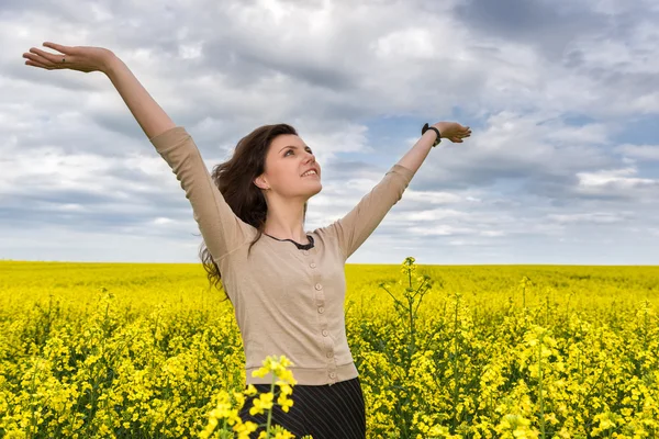 Woman portrait in yellow flower field Royalty Free Stock Images