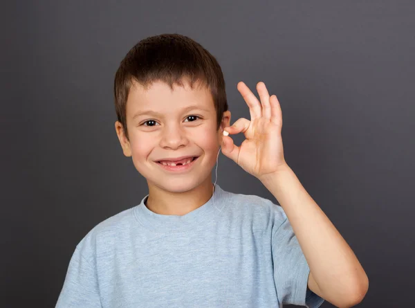 Boy with lost tooth on thread — Stock Photo, Image