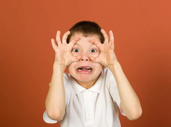 Grimacing boy portrait on brown — Stock Photo, Image