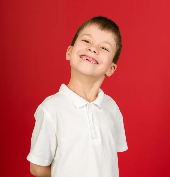 Grimacing boy portrait on red — Stock Photo, Image