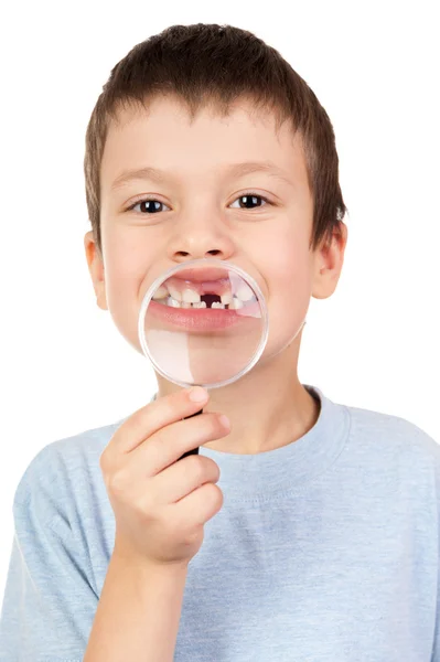 Boy show lost tooth through magnifying glass — Stock Photo, Image