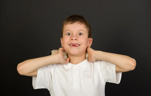 Grimacing boy portrait on black — Stock Photo, Image