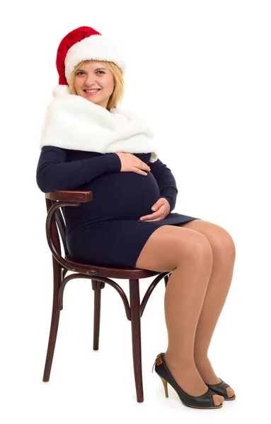 Donna incinta in cappello da Babbo Natale bianco — Foto Stock