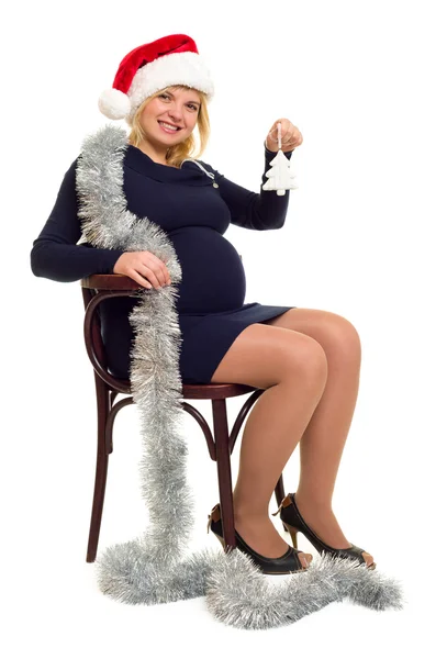 Schwangere Frau mit Weihnachtsmütze auf weißem Hintergrund — Stockfoto