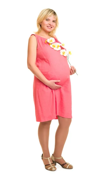 Pregnant woman with flowers in red dress — Stock Photo, Image