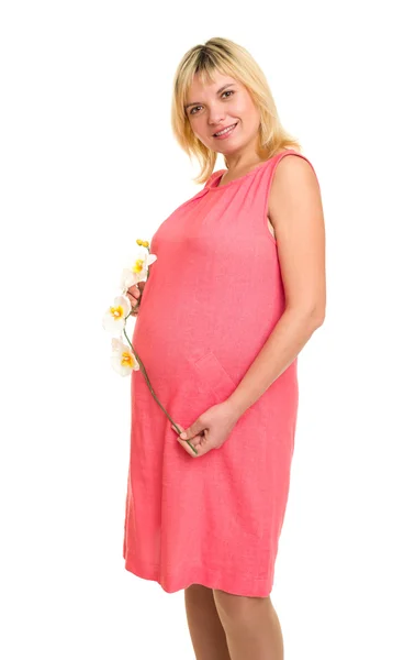 Pregnant woman with flowers in red dress — Stock Photo, Image