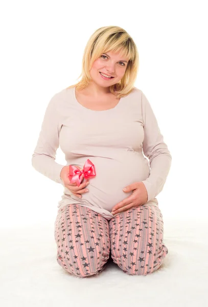 Pregnant woman with red bow — Stock Photo, Image